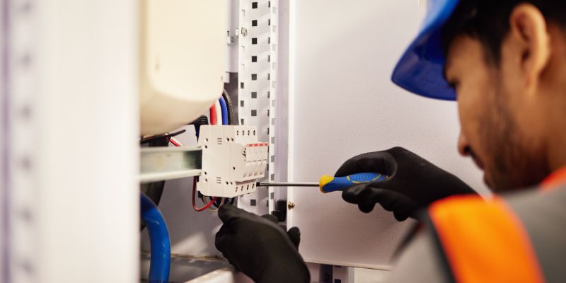 an electrician fixing an electrical generator